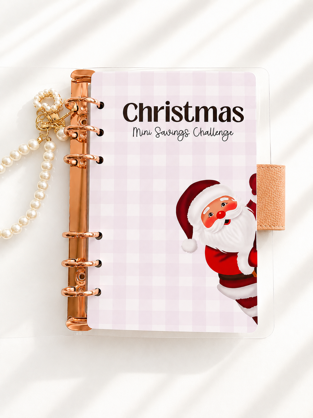 Planner with Santa Claus design and 'Christmas Mini Savings Challenge' text on a white background